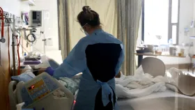 A nurse checks on a patient in the acute care COVID-19 unit at the Harborview Medical Center on Jan. 21, 2022, in Seattle, Wash. Medical spending is up partly due to an uptick in the prevalence of chronic conditions, which has led to more high-cost claims, the study said. Karen Ducey/Getty Images via Getty Images